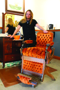 Barber Phil Mills stands at the ready with his vintage crushed-velvet chair. Photo by Molly Oleson.