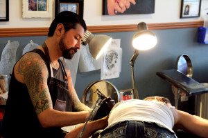 Marcelo Diaz Sepulveda tattoos a client at The Forge Tattoo. Photo by Molly Oleson.