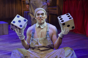 Eddie Lopez, offering up a game of chance, plays Koko in A.C.T.’s production of ‘The Unfortunates’ at the Strand Theater. Photo by Kevin Berne.