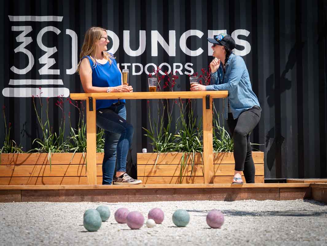 Photo provided by Waz Hewerdine PAIRINGS Two patrons of the Ounces Outdoors soft opening enjoy a brew and a game of bocce.