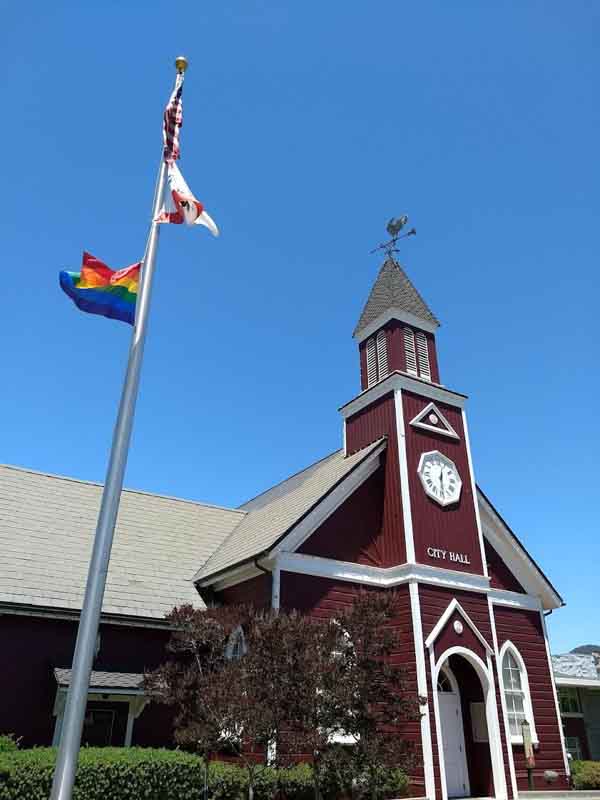 PQ “Pride Month is a great point to consider how to better support the community by looking at the policies, training of staff and by being more visibly supportive with symbols like Pride flags—they mean a lot to the community.” — Adrian Shanker, The Spahr Center Photo by Bill Blackburn PRIDE Last year’s Pride flag raising in front of Novato’s City Hall.