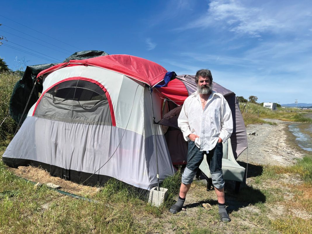 When the Pacific Sun last reported on Sean Derning, Marin County had seized the converted bus he lived in on Binford Road and temporarily put him up in a motel. Now, he’s back on Binford, this time in a tent.