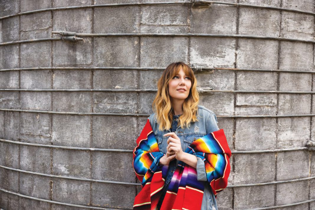 Molly Tuttle is on the road, performing cuts from her latest album, So Long Little Miss Sunshine—a mixture of country and pop that marks a departure from the genre for which she’s generally known. 