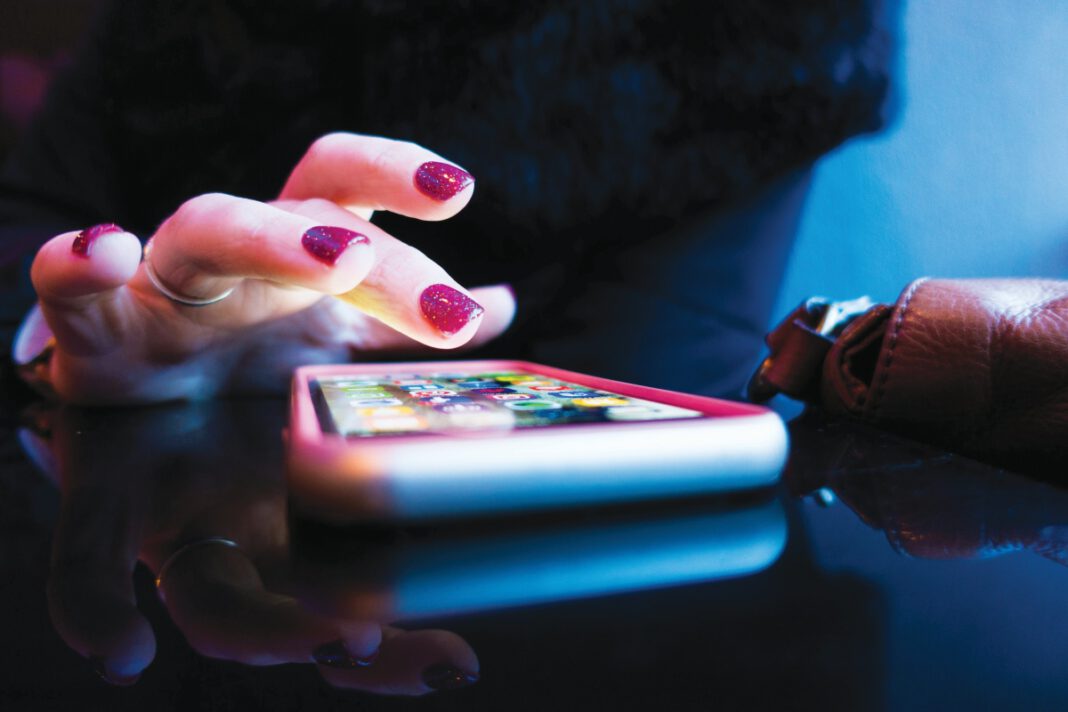Woman using a dating app on a smartphone.