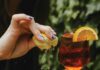 Olema House Offers Creekside Calm and a Place to Unplug A plate of fresh oysters on a table with a woman squeezing a lemon over them.