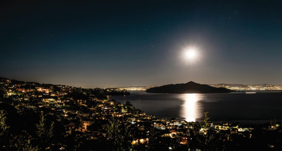 Full moon shining over the Marin landscape and water.