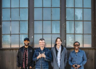 Still Shakin’: North Mississippi Allstars at Sweetwater North Mississippi Allstars members standing in front of a building,