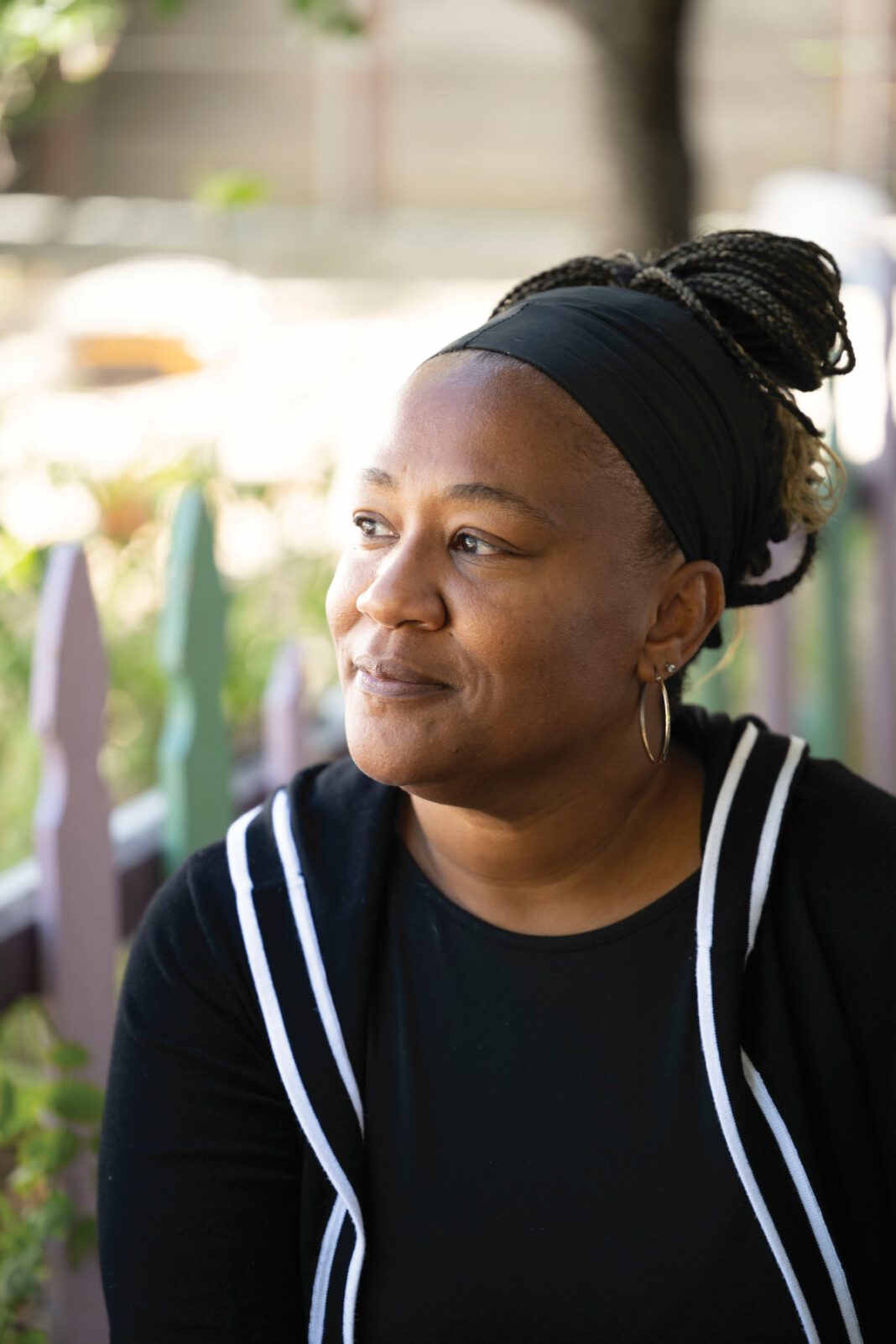Kieawnie Clar in an outdoor setting, wearing a black headband and black top with white trim