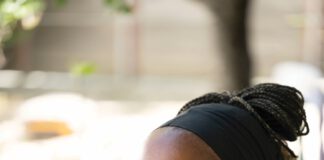 Kieawnie Clar in an outdoor setting, wearing a black headband and black top with white trim