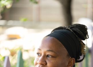 Kieawnie Clar in an outdoor setting, wearing a black headband and black top with white trim
