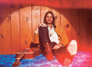 Darkness & Glory, Duane Betts & Palmetto Motel in Mill Valley Duane Betts sits on a blue carpet next to a guitar.