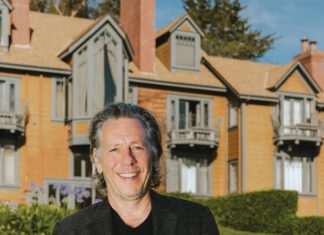 Oysters in Olema: Frank Caiazzo on Family Recipes and West Marin A smiling man in a blazer stands on a lawn in front of a large shingled house with balconies.