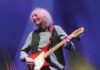 Albert Lee, “Mr. Telecaster,” Rocks Novato at Cookout Concert Albert Lee, 82, with light, wavy hair plays a red electric guitar onstage under blue and gold lighting.