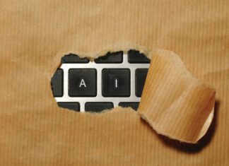 On Artificial Influence: Foreign Campaigns Have Hand in Domestic AI Concerns A torn section of brown kraft paper reveals a black computer keyboard with only "A" and "I" keys visible.