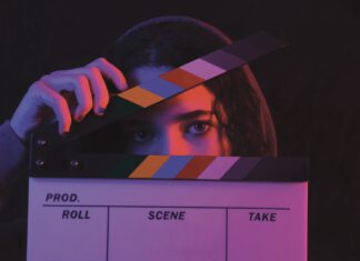 The Mill Valley Film Festival Returneth A person's eyes peek over a film clapperboard, one hand holding the slate open.