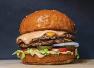 Burger Bash: Bay Area Burger Week Back on the Menu A double-patty cheeseburger with melted cheese, pink sauce, lettuce, tomato, pickles and onion on a sesame bun.