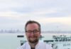 Regionality Reigns: Chris Ball Plans Perfect Last Meal A smiling man with graying hair, eyeglasses and a beard stands with his arms crossed wearing a white chef’s coat.