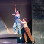 Monet, Monet: ‘Defying Gravity’ at College of Marin One female actor, standing on a gray ledge, is held up by another female performer.